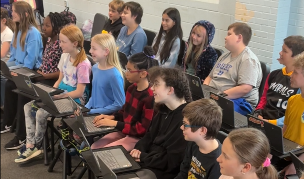 Students playing together in ensemble using Songcraft on their devices